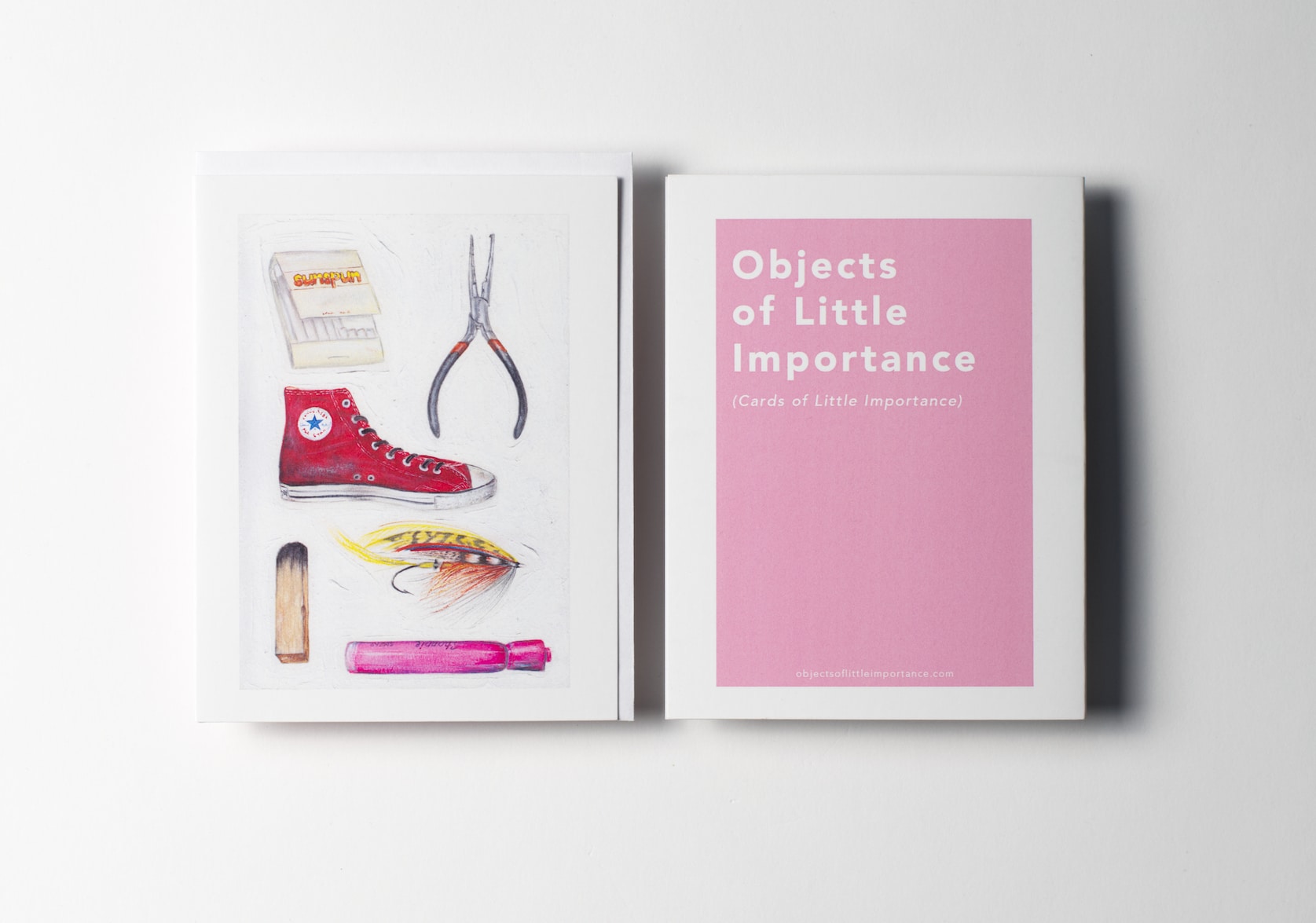 White greeting card featuring paintings of a matchbook, a converse sneaker, pliers, a salmon fly, a palo santo stick, and a pink highlighter. Back of the card is a pink rectangle with white text that reads: Objects of Little Importance (Cards of Little Importance).