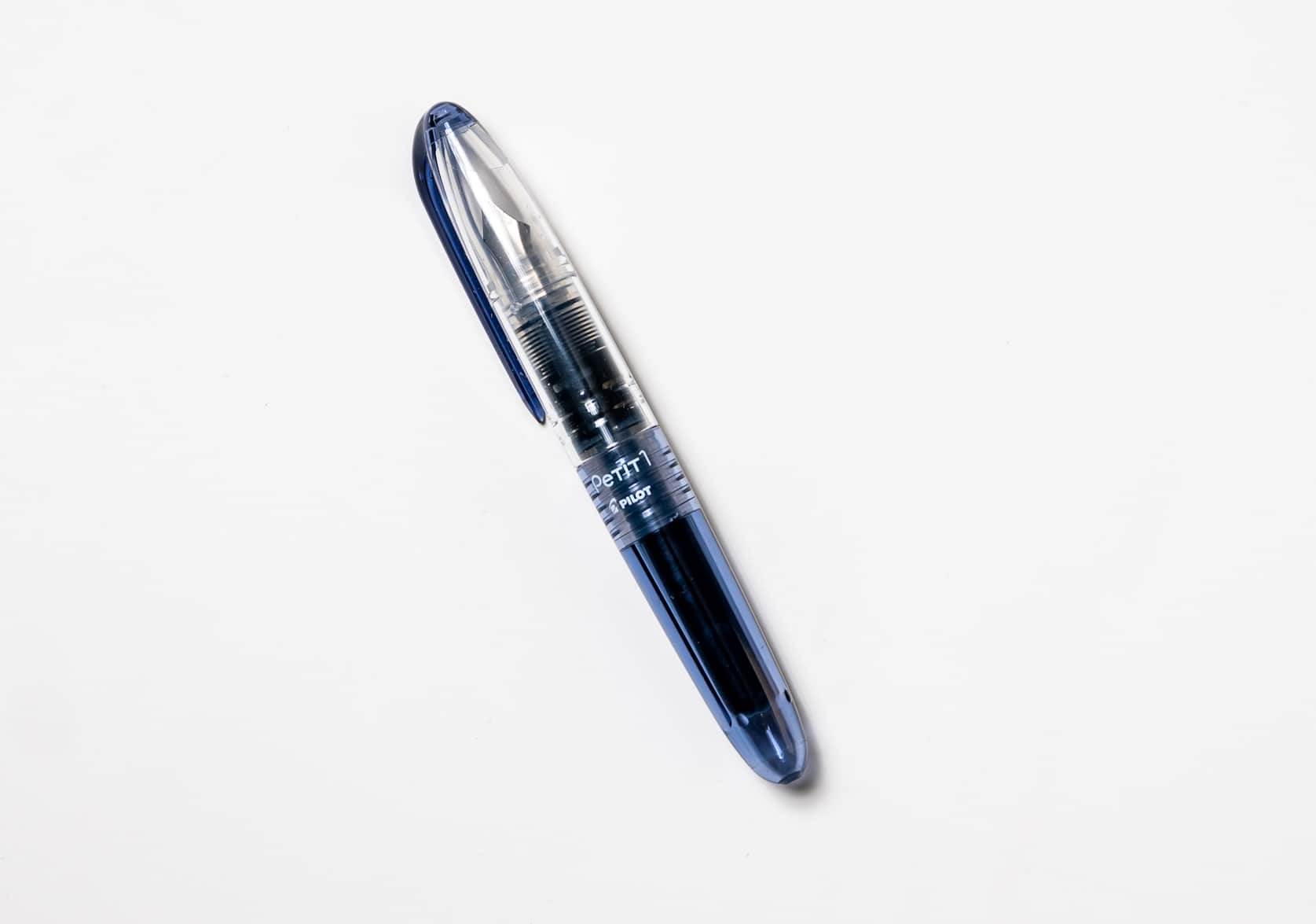 Small blue black fountain pen with a clear cap and blue clip. White text that reads: Petit1 Pilot