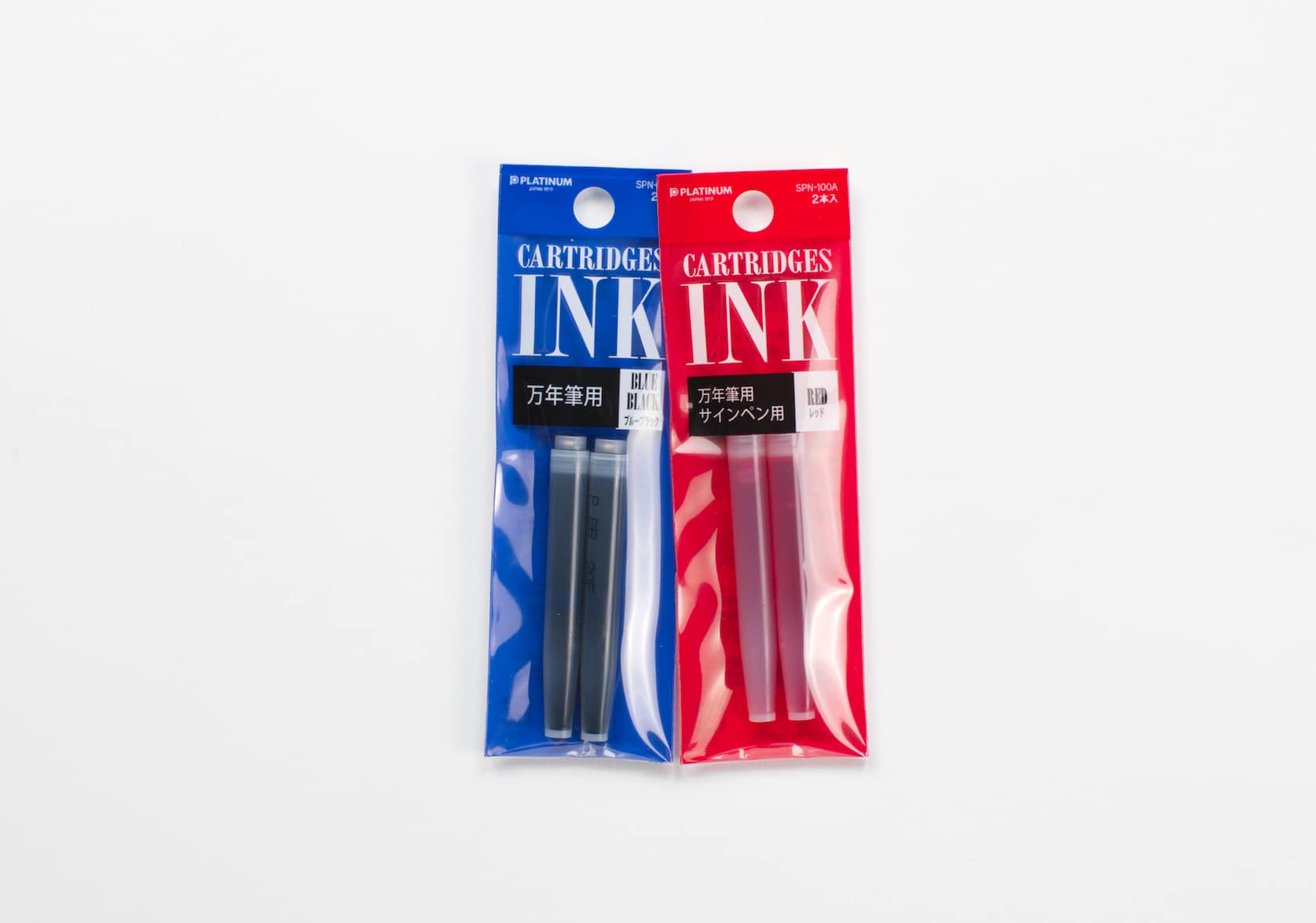 Two packages, one blue and one red, containing two sets of ink cartridges. Text reads: Cartridges ink. Blue Black. Cartridges ink. Red.