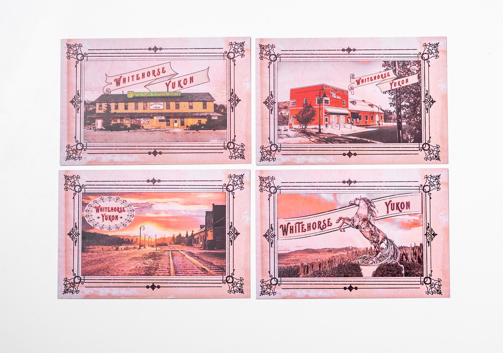 Set of four Whitehorse Yukon Postcards. Each postcard features colourful illustrations of different landmarks framed with a black decorative border. A banner is displayed on each postcard with red text that reads: Whitehorse, Yukon.