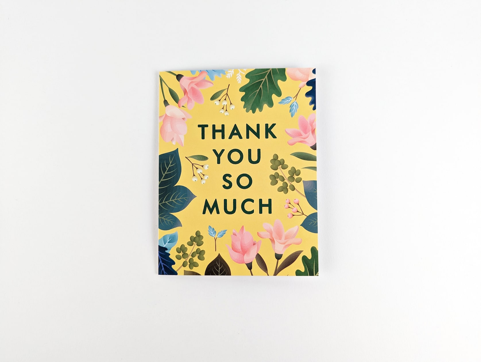 Yellow card with green text in the centre that reads: THANK YOU SO MUCH. A variety of pink flowers, green & blue leaves, white and pink berries with brown stems are featured around the text.