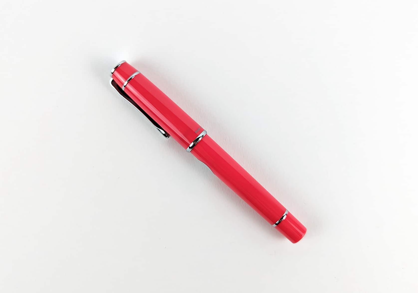 Vivid pink fountain pen with silver pen clip.