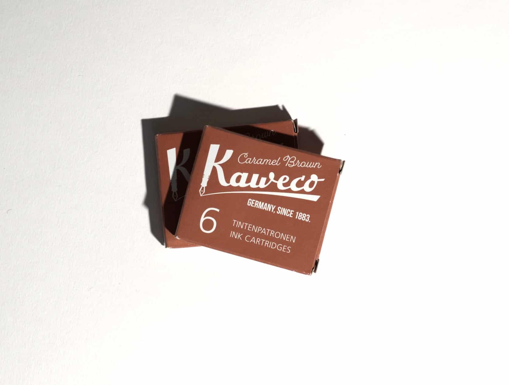 Two boxes of ink cartridges lie on a white surface. Text on packaging reads: Kaweco. Caramel Brown. Germany, since 1883. 6 Tintenpatronen. Ink Cartridges.