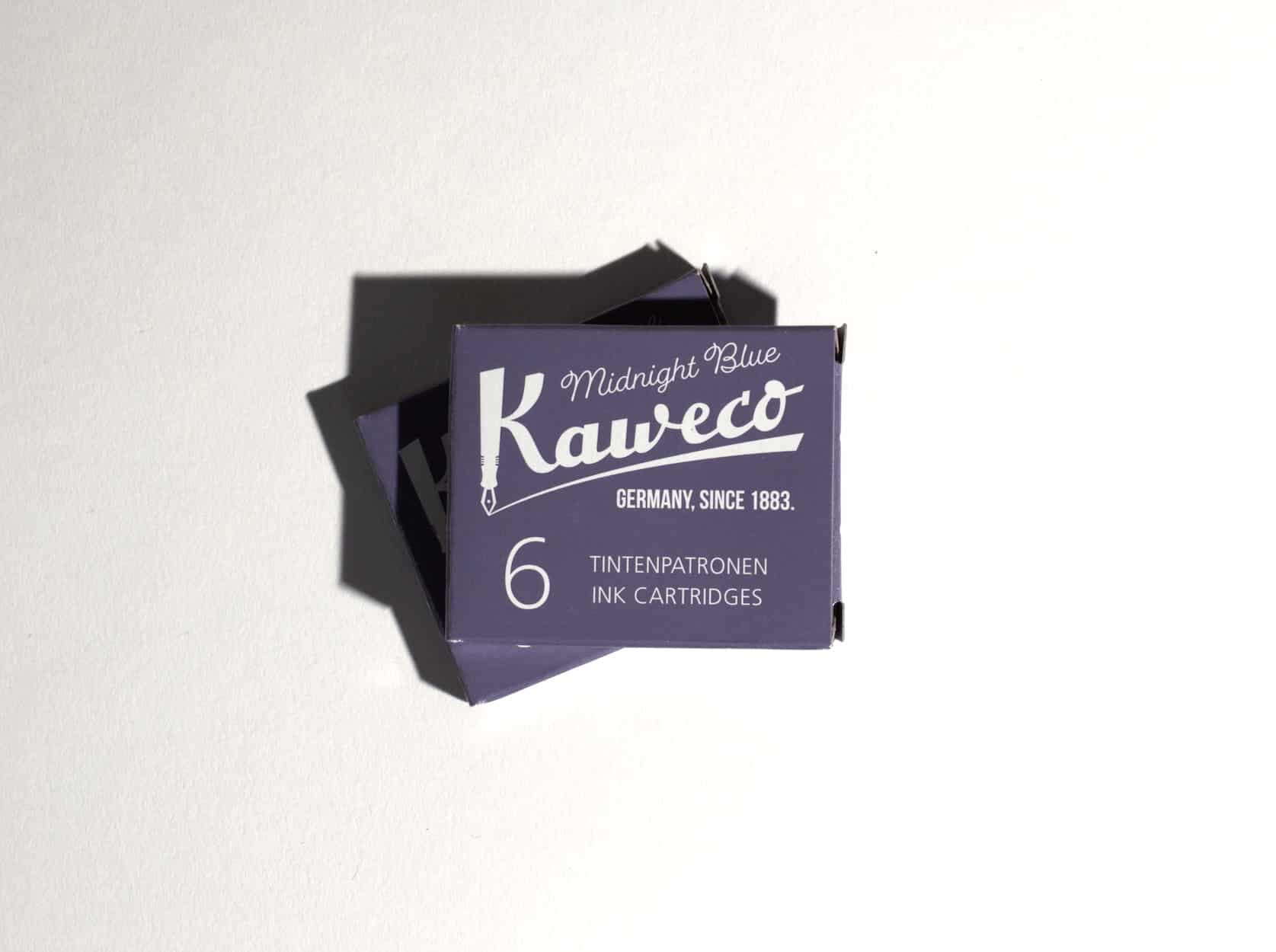 Two boxes of ink cartridges lie on a white surface. Text on packaging reads: Kaweco. Midnight Blue. Germany, since 1883. 6 Tintenpatronen. Ink Cartridges.