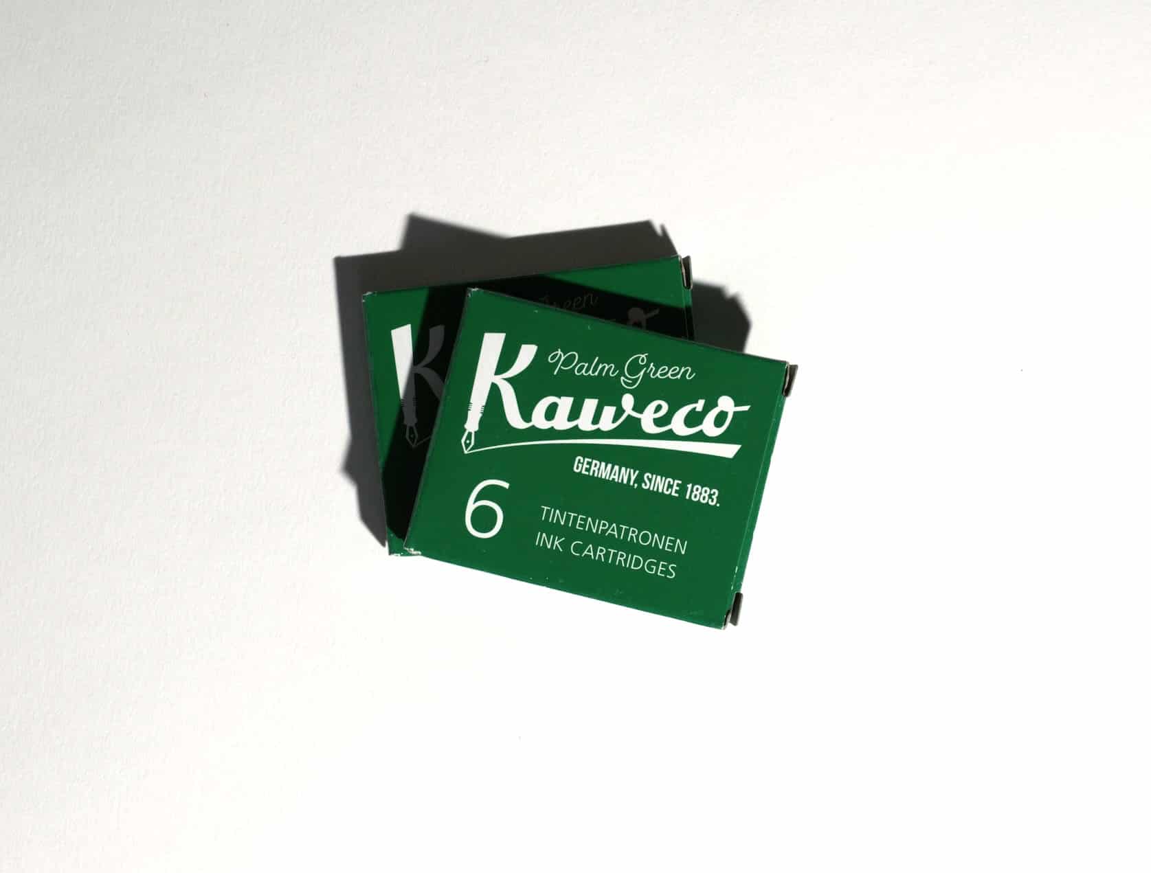 Two boxes of ink cartridges lie on a white surface. Text on packaging reads: Kaweco. Palm Green. Germany, since 1883. 6 Tintenpatronen. Ink Cartridges.