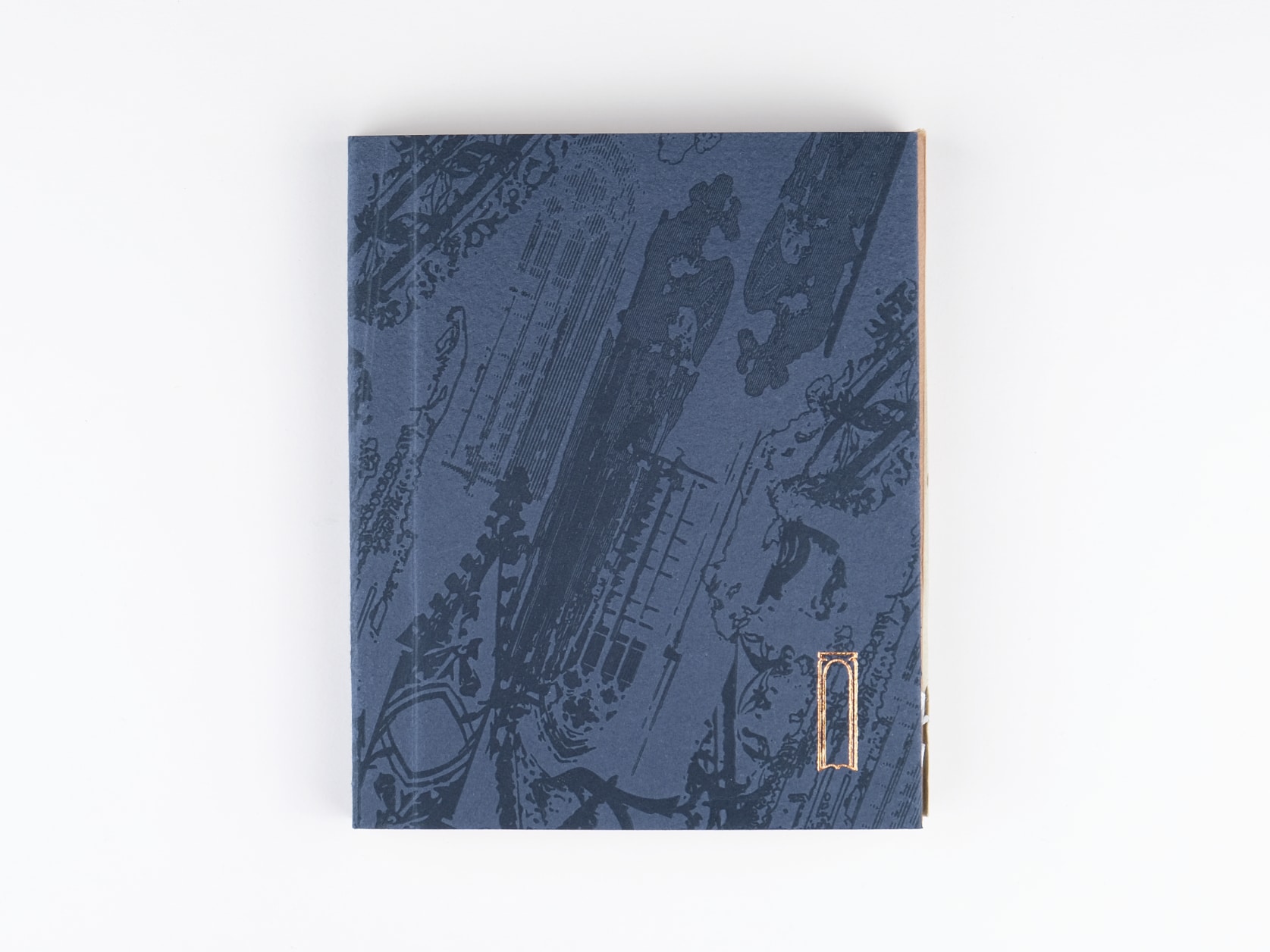 A dark blue journal with an embossed cathedral pattern on its cover